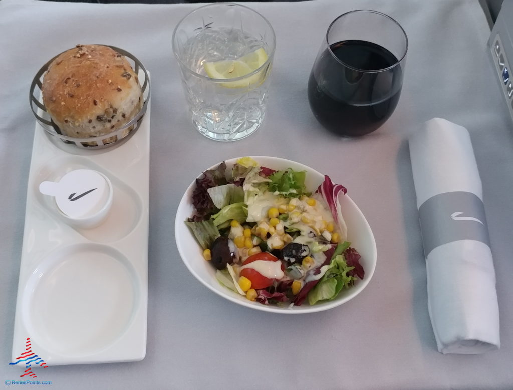 a plate of salad and a glass of water