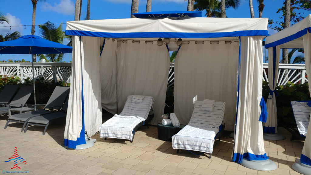 a two lounge chairs under a canopy