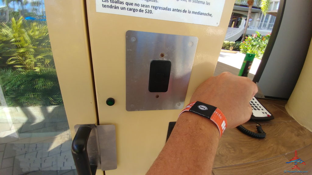 a person's arm with a wristband on a door
