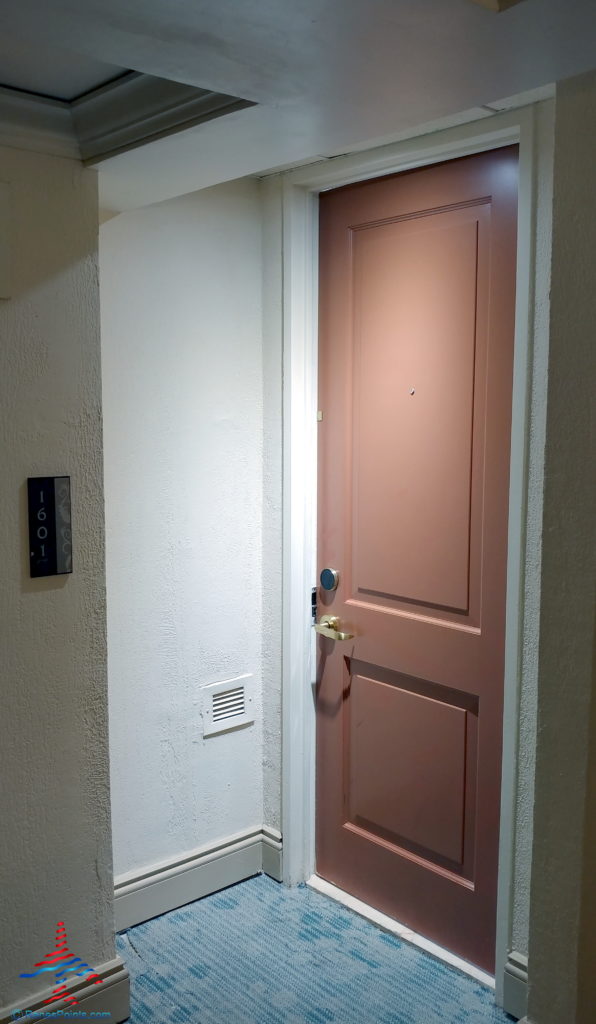 a pink door with a gold handle