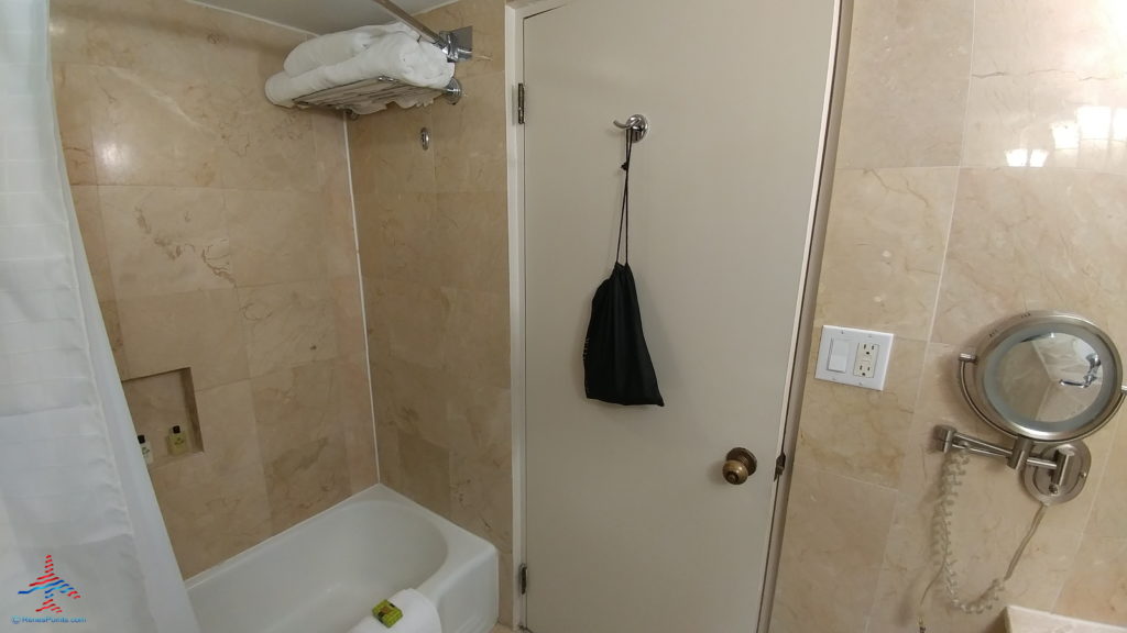a bathroom with a bag on a hook