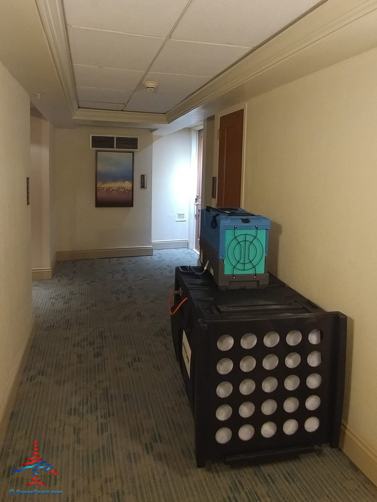 a hallway with a large black box and a blue box on top