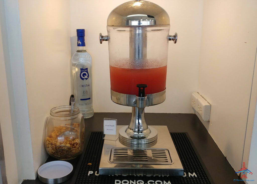 a drink dispenser with a red liquid in it