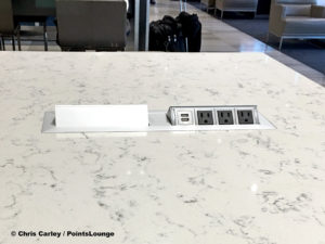 USB ports and power outlets are seen atop a high table at the United Club LAX airport lounge in Los Angeles, California.