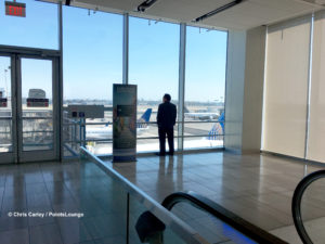 A guest looks at airplanes during a visit to the United Club at LAX airport lounge.