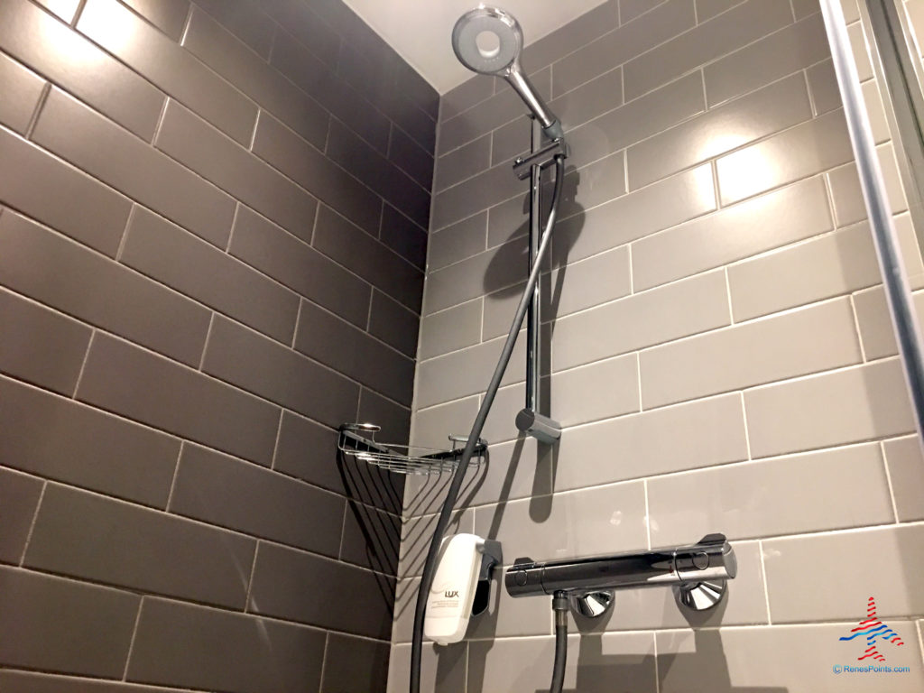 The bathroom shower is seen inside a room at the Holiday Inn Express London Heathrow T4 (LHR airport hotel) in Hounslow, United Kingdom.