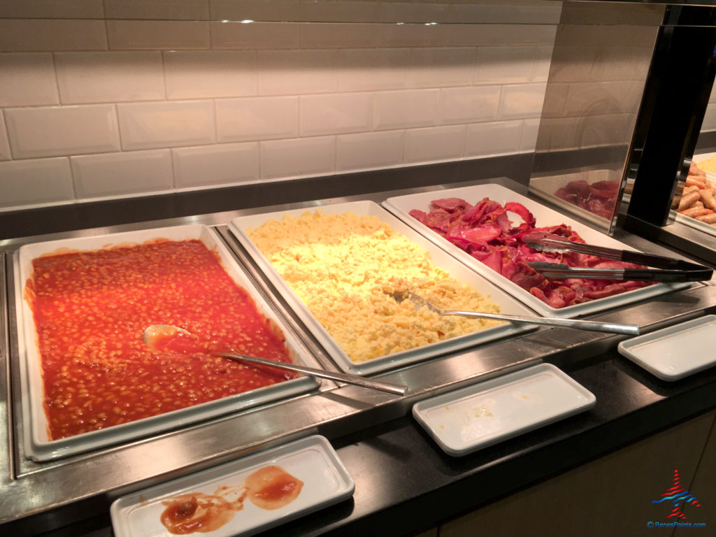 Beans, eggs, and breakfast are seen at the Holiday Inn Express London Heathrow T4 (LHR airport hotel) breakfast buffet in Hounslow, United Kingdom.