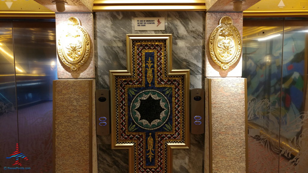 a mosaic door with two lights on the wall