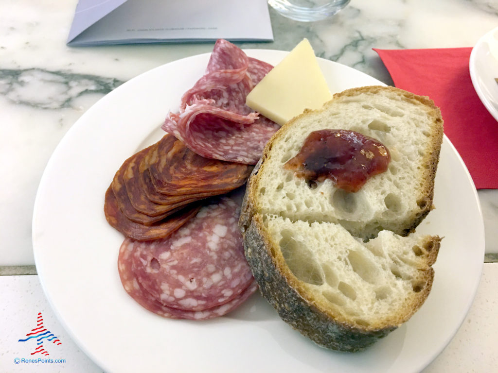 Charcuterie, jelly, and bread are seen inside the Virgin Atlantic Clubhouse airport lounge at London Heathrow Airport (LHR).