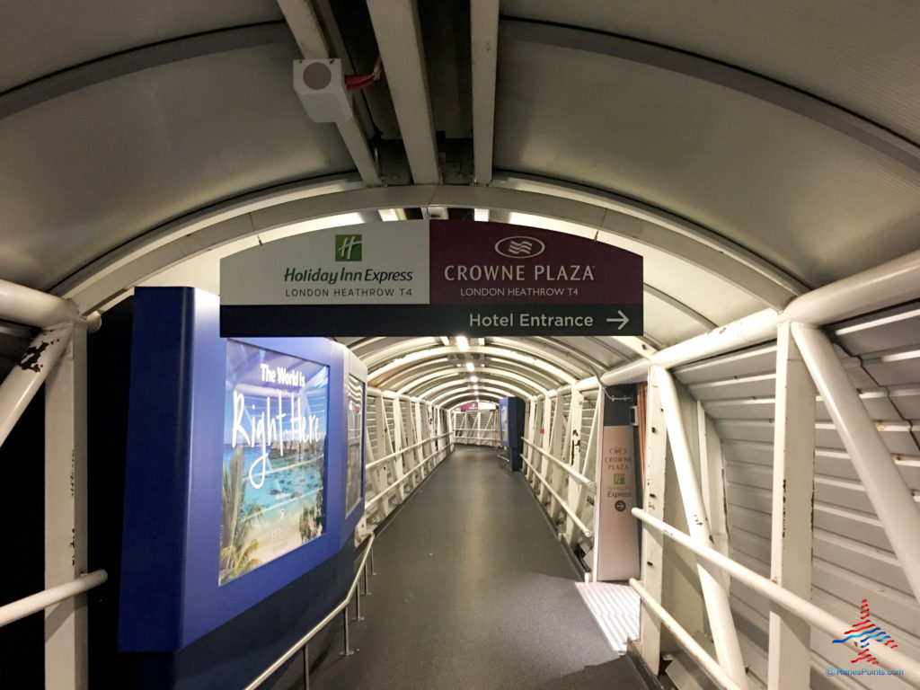 Signage in a tunnel directs guests to the Crowne Plaza and Holiday Inn Express, Hilton, and Premier Inn LHR airport hotels in Hounslow, United Kingdom.