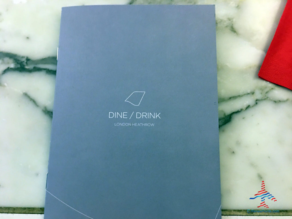The cover of the Dine / Drink (food and beverage) Menu is seen inside the Virgin Atlantic Clubhouse airport lounge at London Heathrow Airport (LHR).