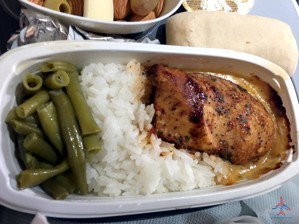 Marinated chicken breast, green beans, rice, and bread are featured as part of Delta's Main Cabin international experience as seen on a Delta Air Lines Airbus A330-300 flight from London Heathrow to Atlanta Hartsfield Airport.
