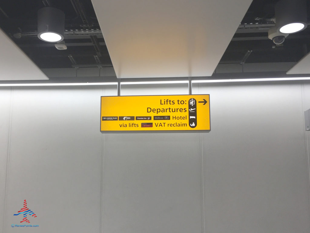 Signage inside Terminal 4 at Heathrow Airport directs guests to the Crowne Plaza, Holiday Inn Express, Hilton, and Premier Inn LHR hotels in Hounslow, United Kingdom.