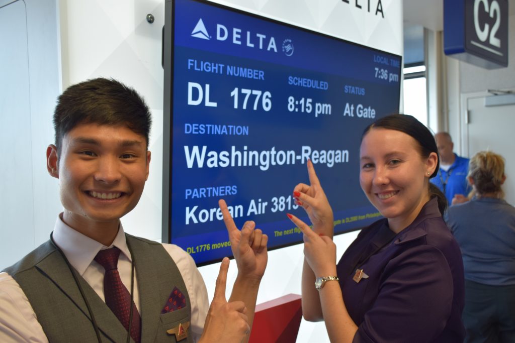 Delta Air Lines employees point to a sign at Minneapolis-St. Paul International Airport prior to Delta Air Lines flight 1776 to Regan National Airport in Washington, D.C.