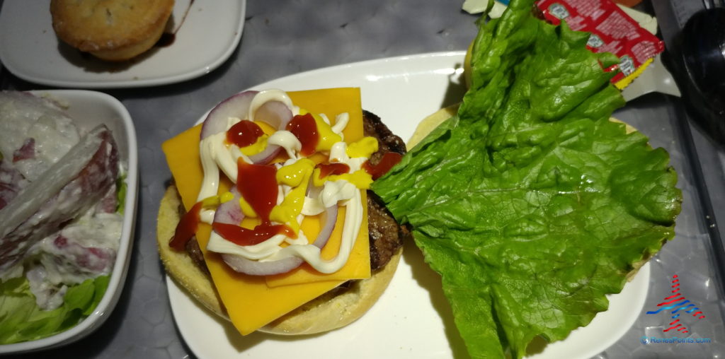a burger with cheese and ketchup on top