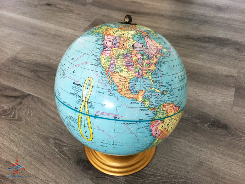A model globe of Earth rests on an axis.