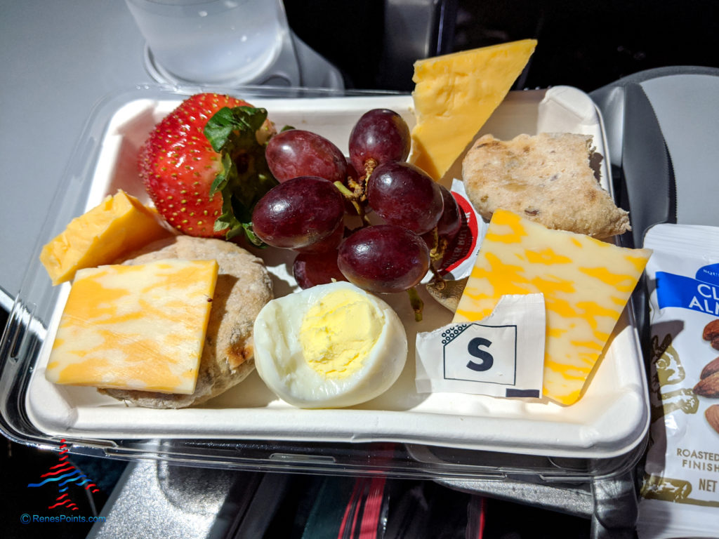 Cheeses, grapes, a strawberry, egg, and whole grain museli snacks are served in the Delta Air Lines Flight Fuel Protein Box premium snack.