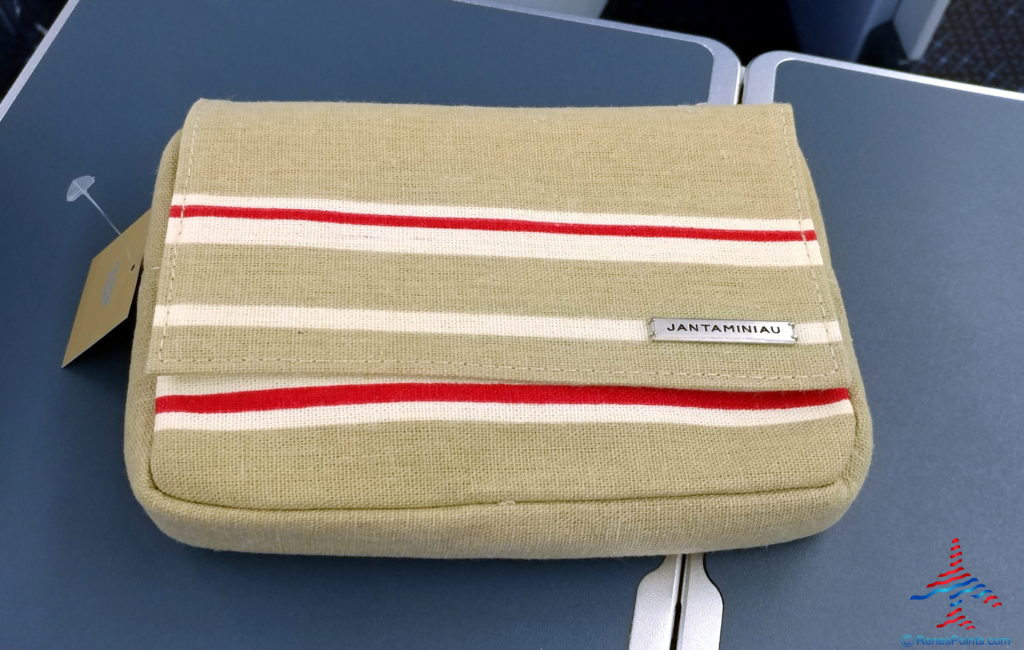 a beige and red striped purse