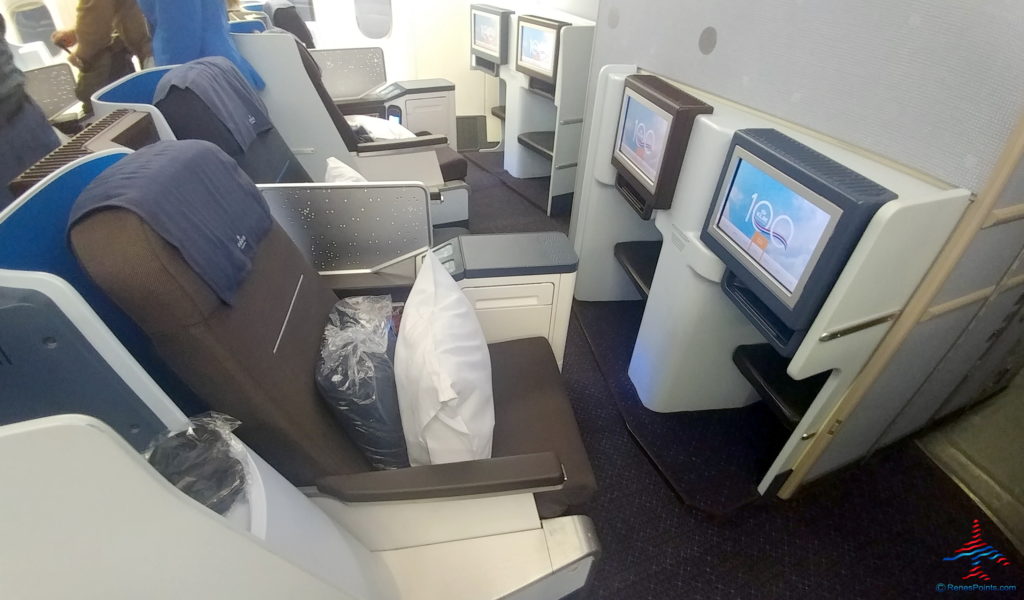 a row of seats with tvs and monitors