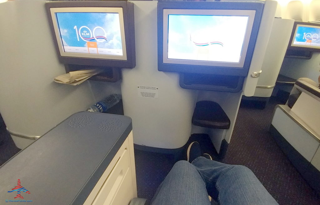 a person's legs in front of a pair of monitors