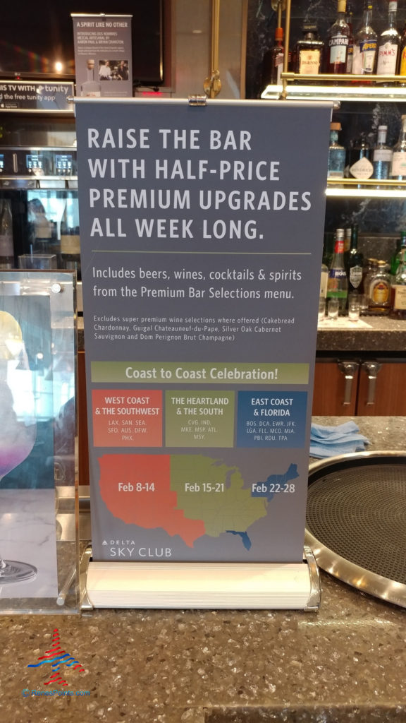 A sign displayed at a Delta Sky Club announces a premium drink upgrade special in effect during February 2020.