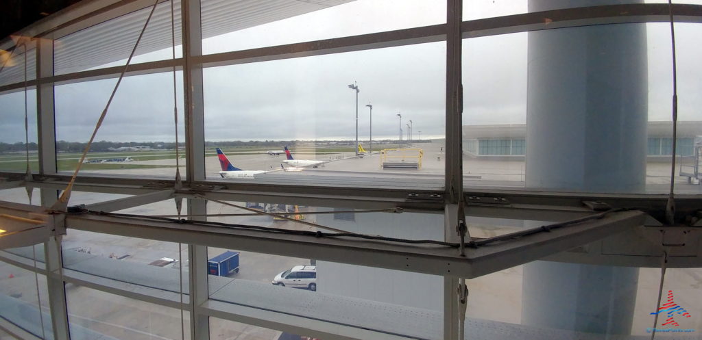 a window with a view of planes and cars