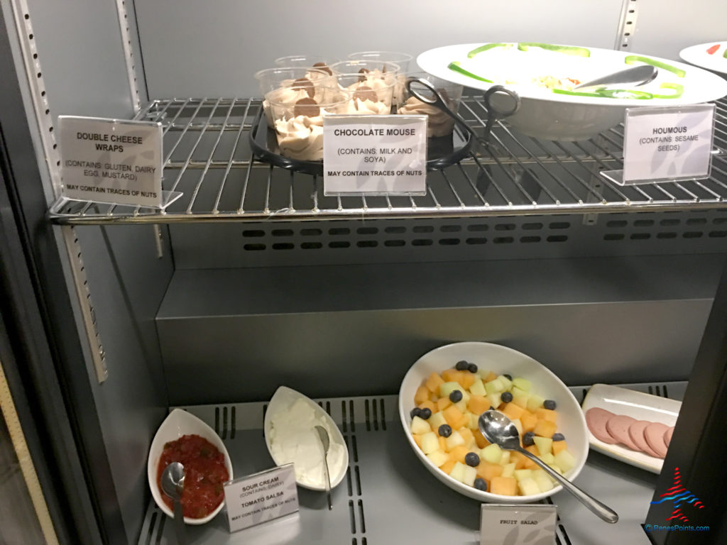 Desserts, fruit, salsa, sour cream, and meats are seen at the Plaza Premium Arrivals Lounge at London Heathrow Airport Terminal 4.