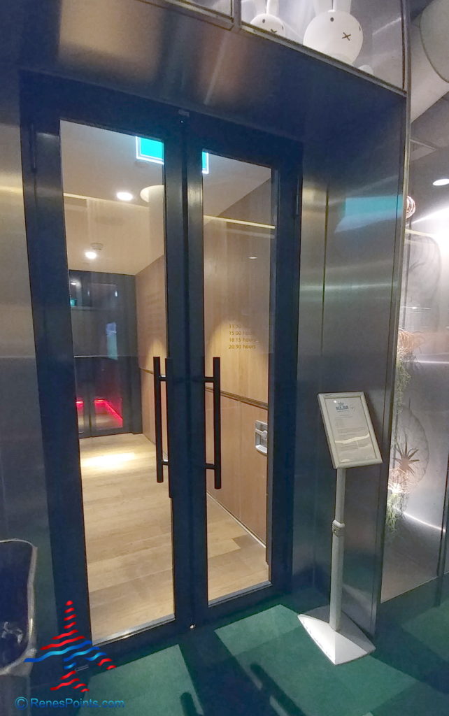 a glass doors with a wood floor and a sign