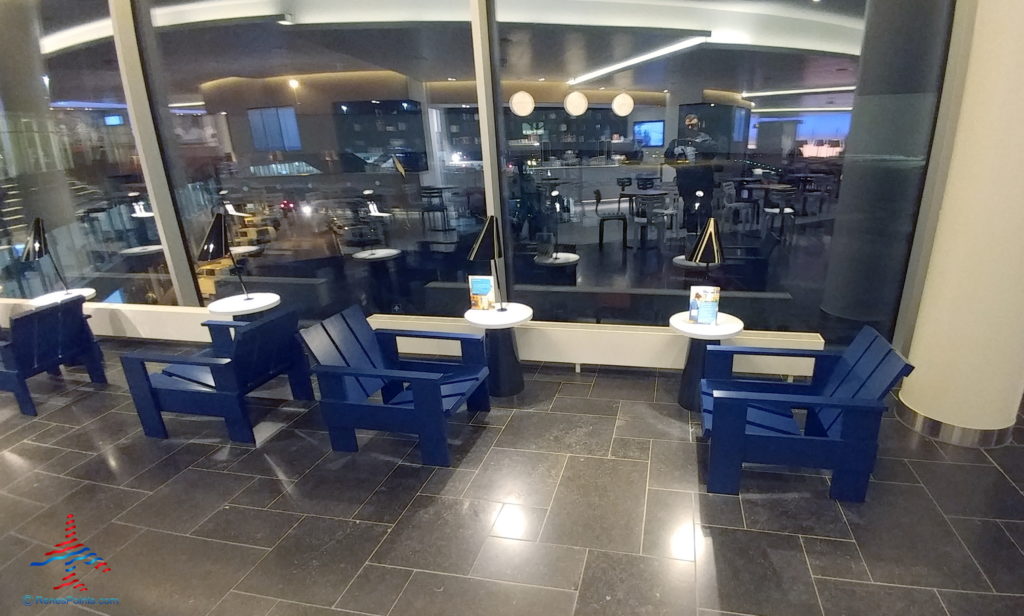 a room with blue chairs and tables