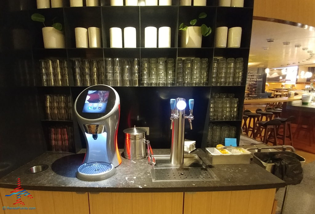 a bar with a drink dispenser and a drink dispenser