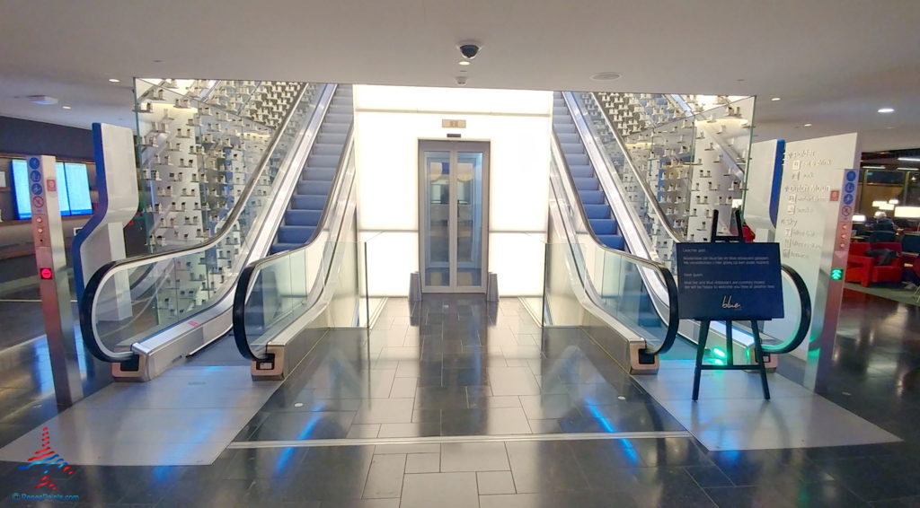 an escalator with a glass door
