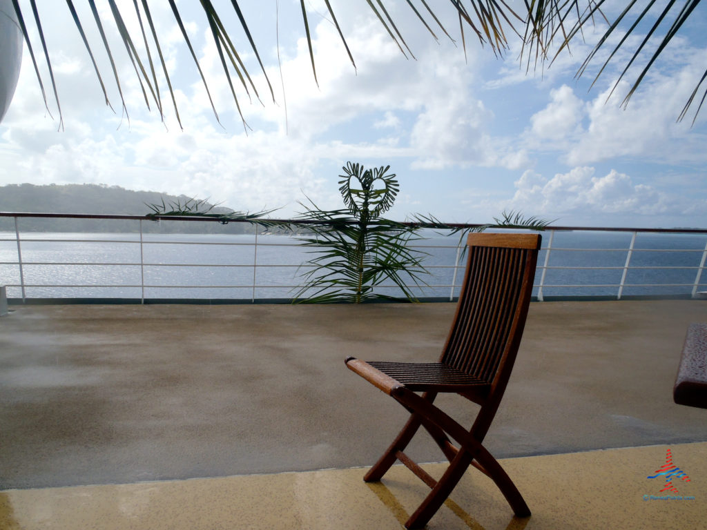 A chair and palm arrangement are seen prior to a wedding on the deck of the M/S Paul Gauguin Cruise ship.