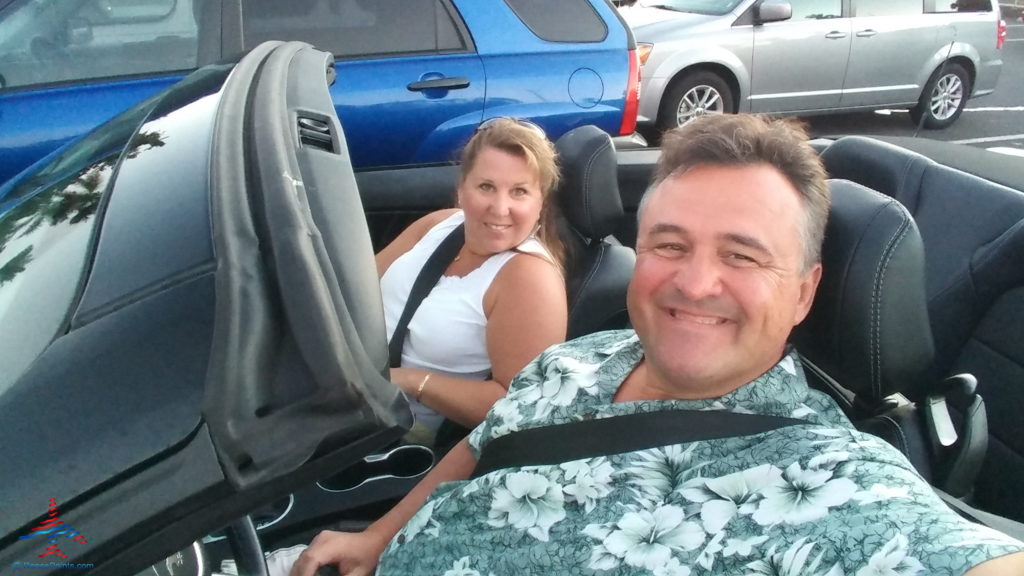 a man and woman in a convertible car