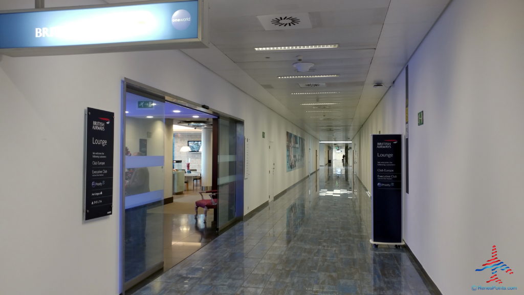 a long hallway with a sign on the wall