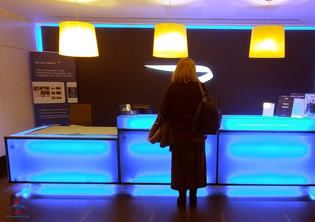 a woman standing in front of a blue lit counter