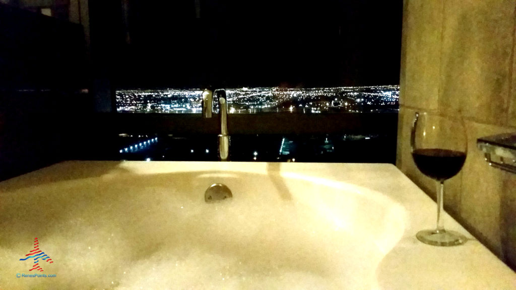 Enjoying a bath and glass of red wine inside a Salon Suite hotel room at Palms Casino Resort in Las Vegas, Nevada.