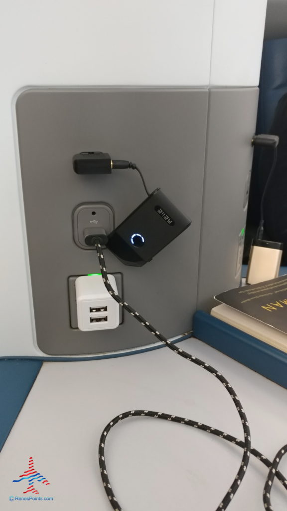 a black and white device with a cord plugged into it