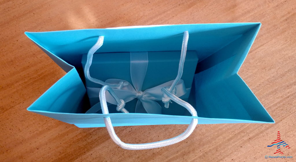 a blue bag with a gift box inside
