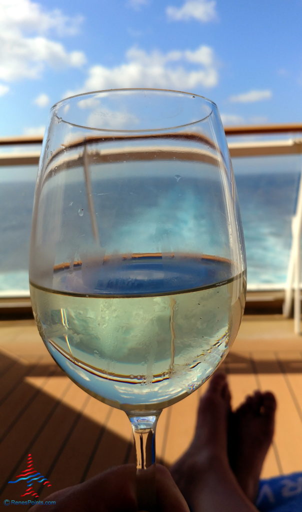 a glass of wine on a deck