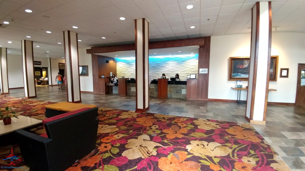 a lobby with a colorful rug and a couch