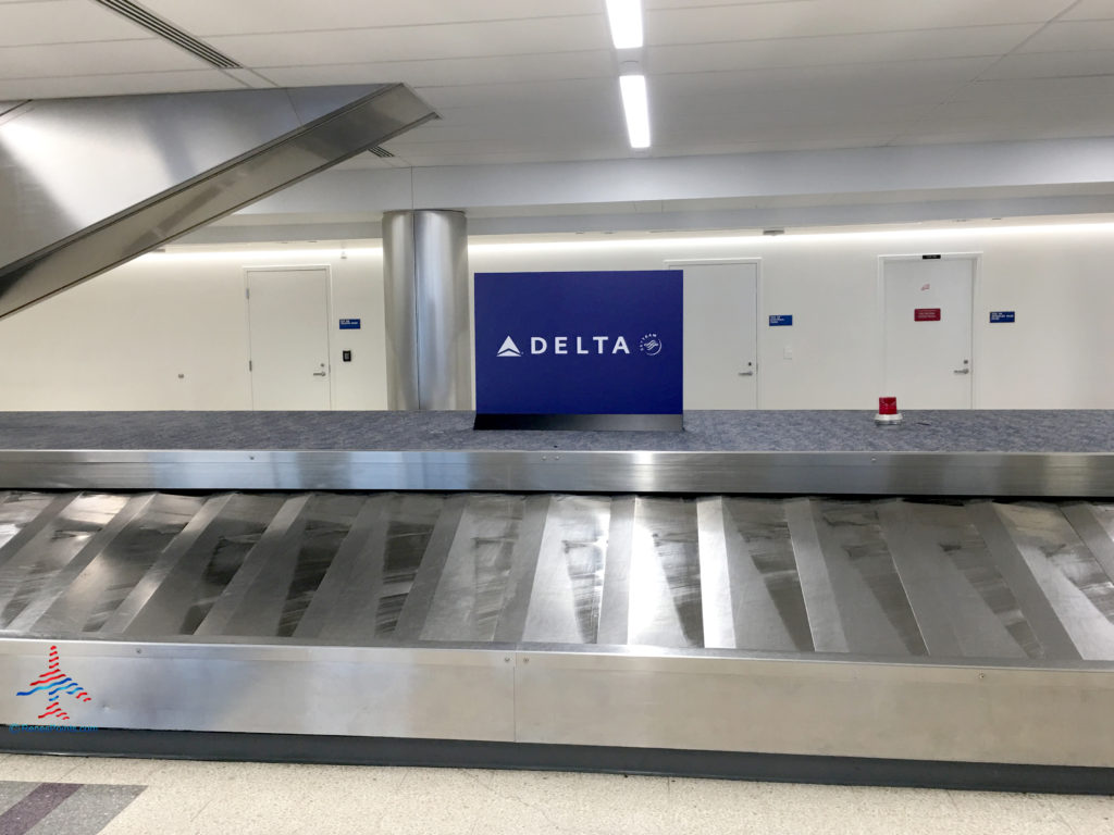 A Delta Air Lines luggage carousel in the baggage claim area of a Los Angeles International Airport (LAX) terminal.