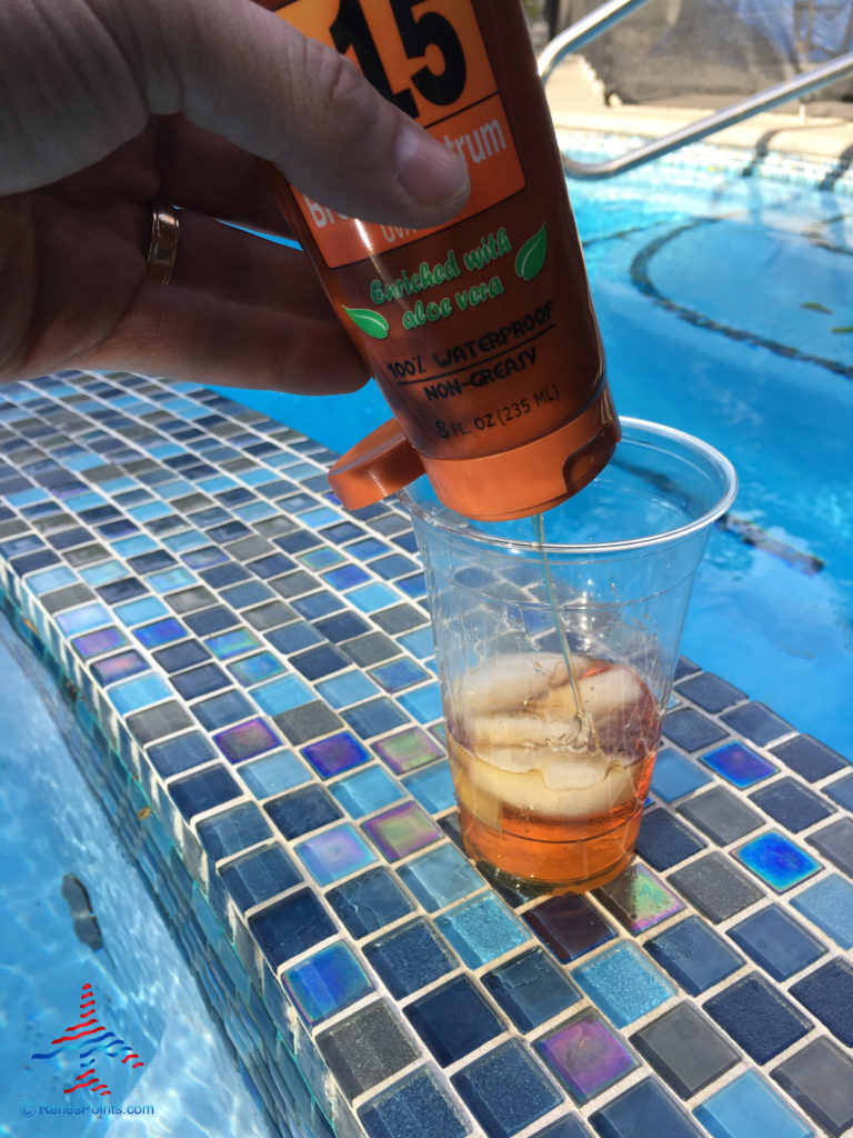 A pool goer pours bourbon into from a sunscreen flask.