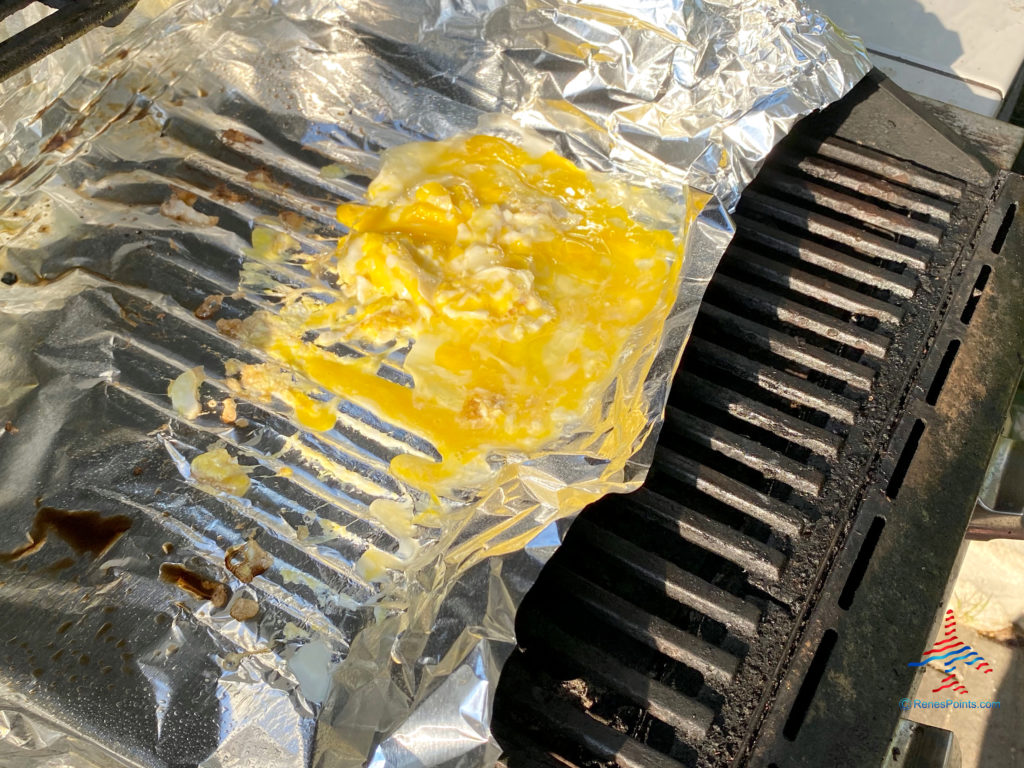 Making scrambled eggs on a grill.