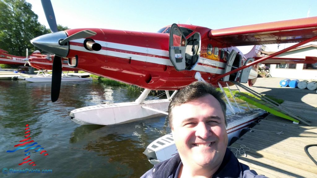 a man taking a selfie with a red and white plane