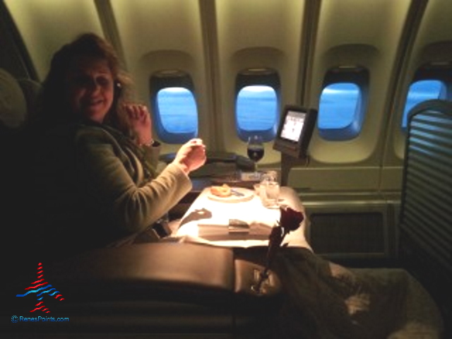 a woman sitting at a table in an airplane