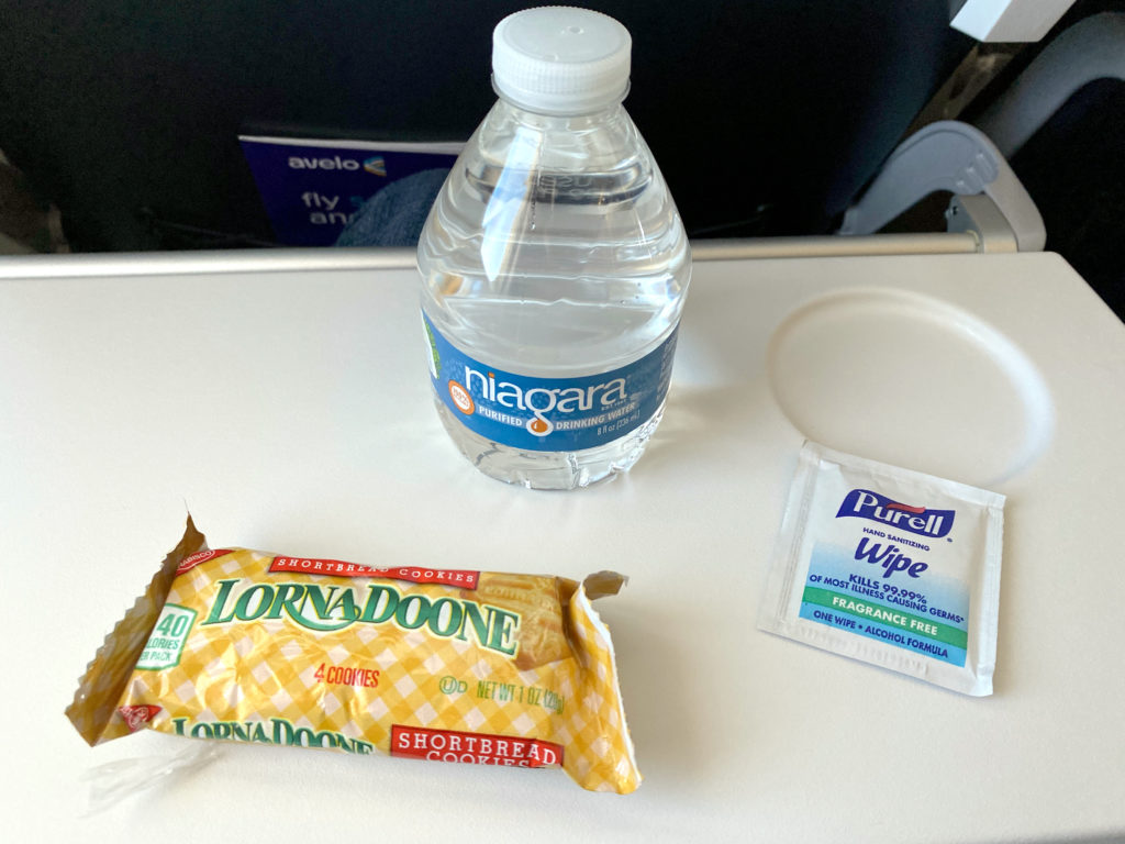 Niagra water, Lorna Doone cookies, and a Purell wipe are seen on a tray table during Avelo Airlines’ first passenger flight, XP101. The trip traveled from Hollywood Burbank Airport in Burbank, California (BUR) to Charles M. Schulz–Sonoma County Airport in Santa Rosa, California (STS) on Wednesday, April 28, 2021.