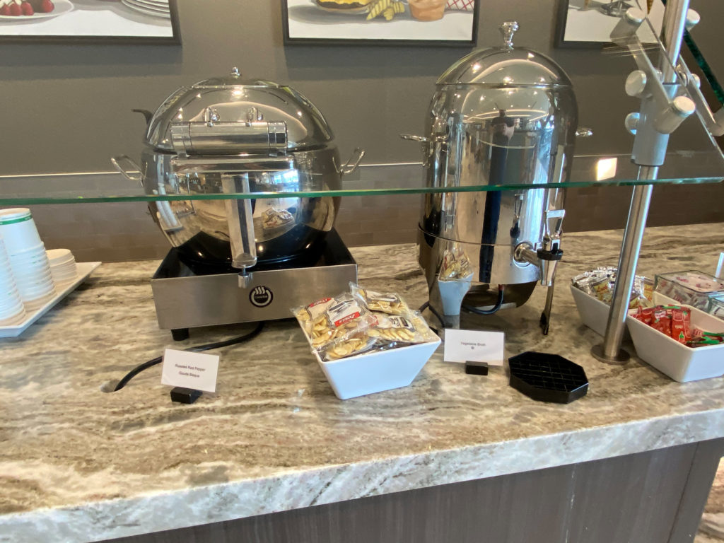 Vegetable broth and roasted red pepper gouda bisque are seen during a visit to the Delta Sky Club Salt Lake City inside Terminal A of Salt Lake City International Airport (SLC). (Photo ©RenesPoints.com)