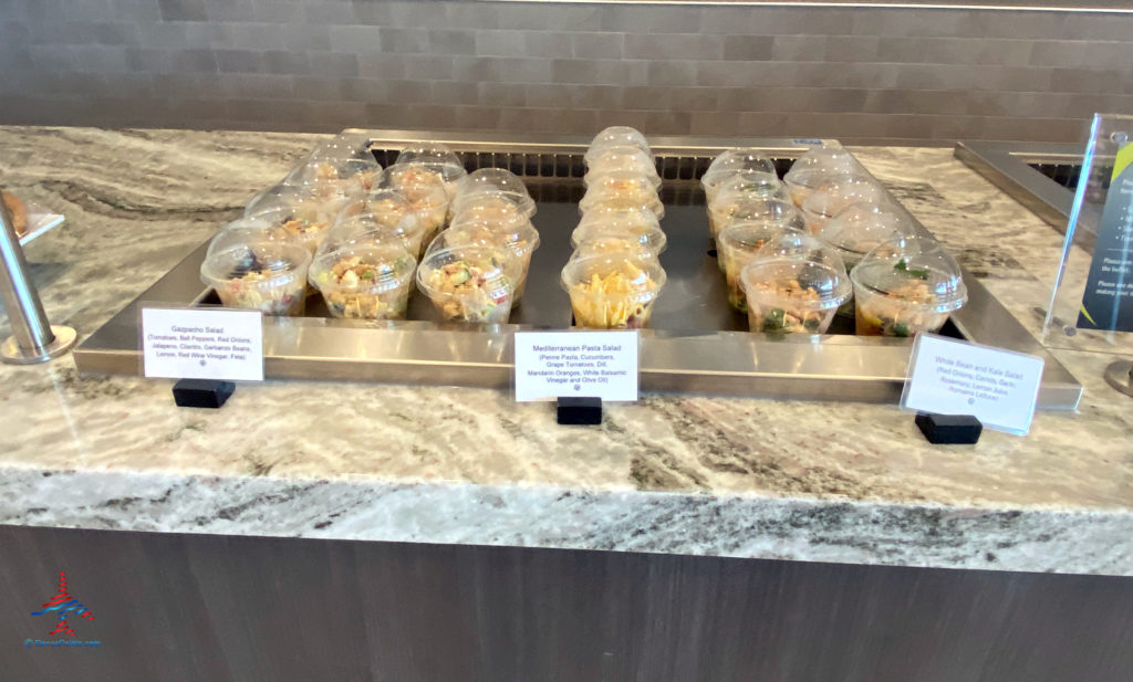 Pre-packaged gazpacho salad, Mediterranean pasta salad, and white bean and kale salad are seen during a visit to the Delta Sky Club Salt Lake City inside Terminal A of Salt Lake City International Airport (SLC). (Photo ©RenesPoints.com)