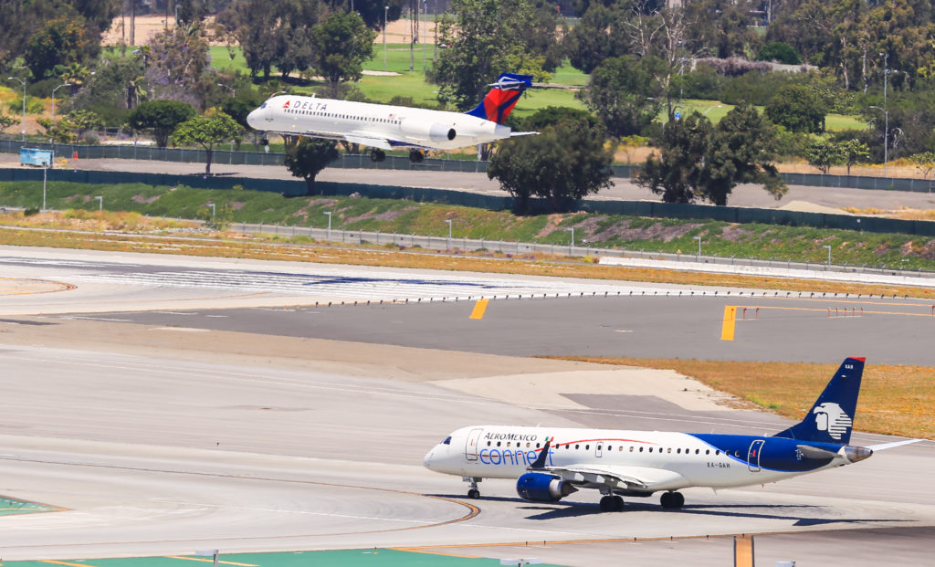 Los Angeles, California, USA - May 22, 2019: An Aeromexico-Plane (ERJ-190) is waiting for take off at the Los Angeles International Airport (LAX). In the background a Delta plane lands. (©iStock.com/mixmotive)