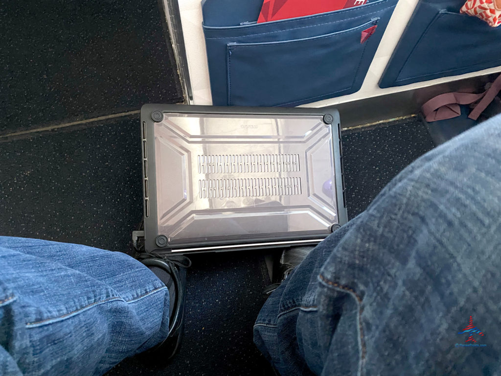 A 2019 Apple MacBook Pro is used during a flight.